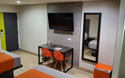 Day use room with TV at Exclusivo Inn & Suites. 