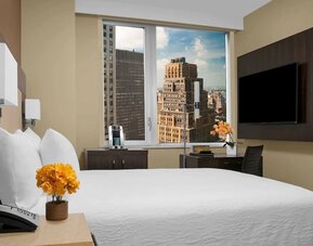 Day use room with work desk, TV screen and private bathroom at Hilton Garden Inn New York/Times Square Central.
