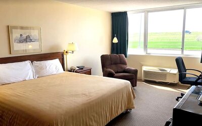 Bright and spacious day use room with work desk and sofa at Norwood Inn And Suites Worthington.