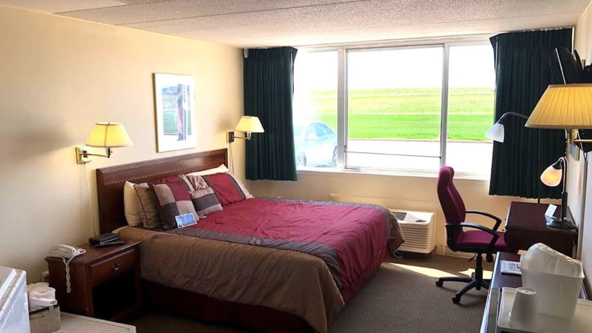 King suite with hot tub and work desk at Norwood Inn And Suites Worthington.