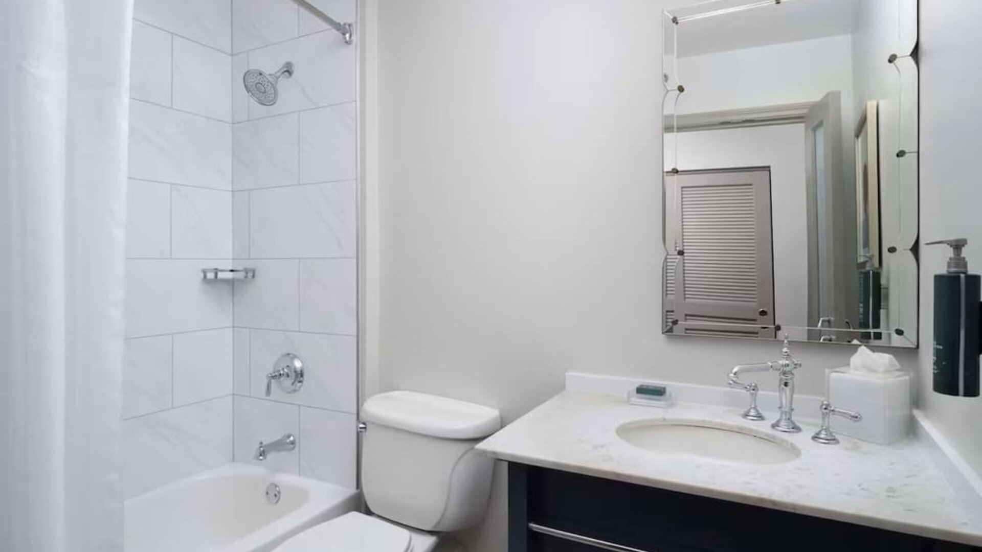 Private guest bathroom with combined tub and shower at Hilton Orrington/Evanston.