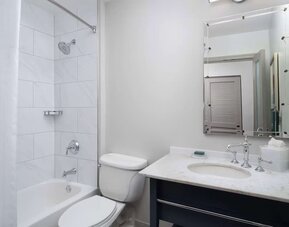 Private guest bathroom with combined tub and shower at Hilton Orrington/Evanston.