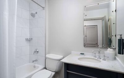 Private guest bathroom with combined tub and shower at Hilton Orrington/Evanston.