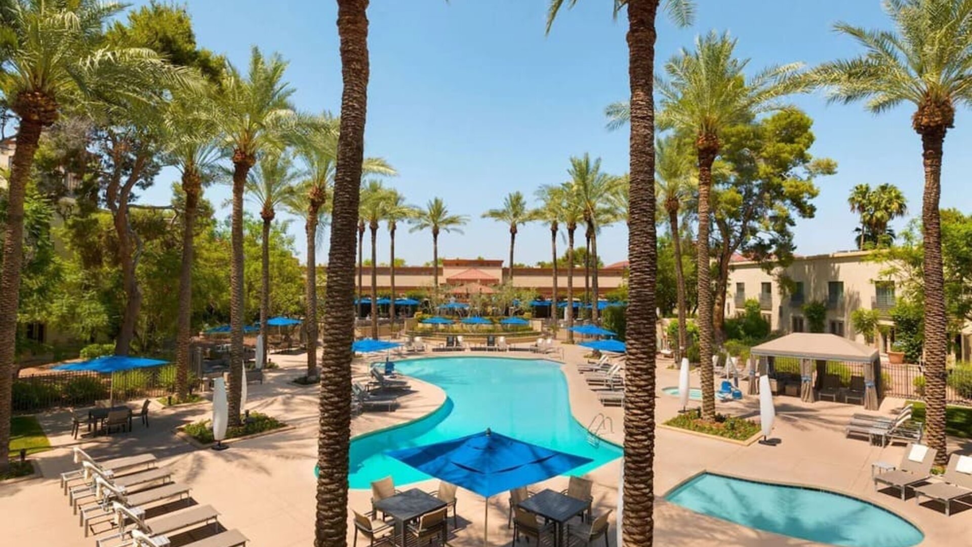 Outdoor pool with lounge chairs at Hilton Scottsdale Resort & Villas.