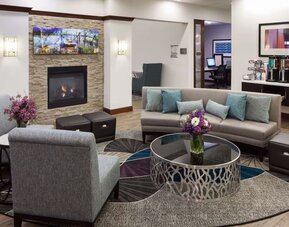 Lobby lounge with fireplace and workspace at Homewood Suites By Hilton Agoura Hills.