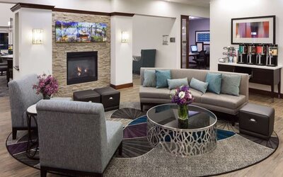 Lobby lounge with fireplace and workspace at Homewood Suites By Hilton Agoura Hills.