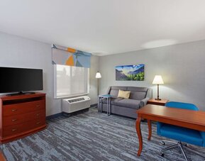Day use suite with work desk and sofa at Hampton Inn & Suites Clovis-Airport North.