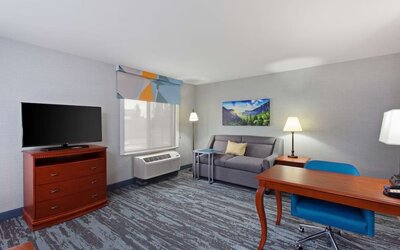 Day use suite with work desk and sofa at Hampton Inn & Suites Clovis-Airport North.