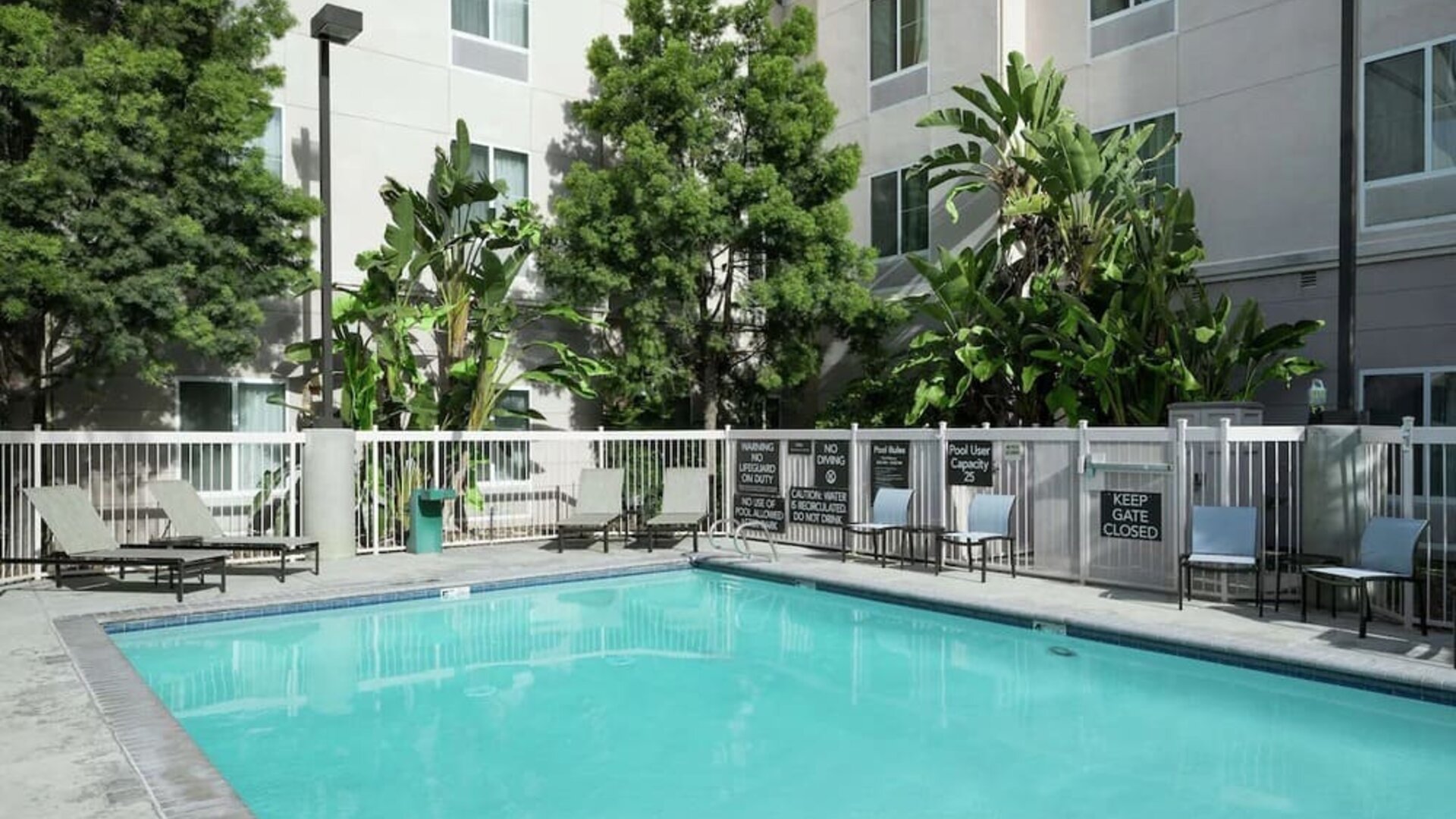 Outdoor pool with lounge chairs at Homewood Suites By Hilton Fresno Airport/Clovis.
