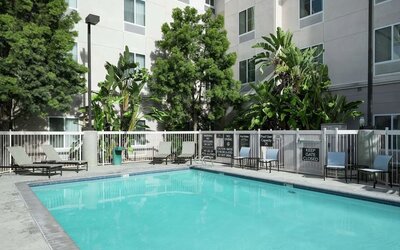Outdoor pool with lounge chairs at Homewood Suites By Hilton Fresno Airport/Clovis.