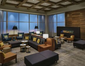 Lobby lounge with fireplace and workspace at Hilton Garden Inn Sunnyvale.
