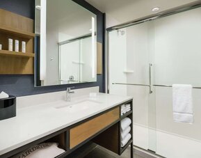 Private guest bathroom with shower and free toiletries at Hilton Garden Inn Sunnyvale.
