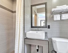 Private bathroom with shower at Mid City Inn - Los Angeles.