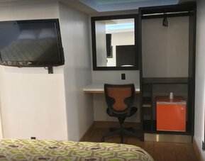 Work desk and TV at Mid City Inn - Los Angeles.