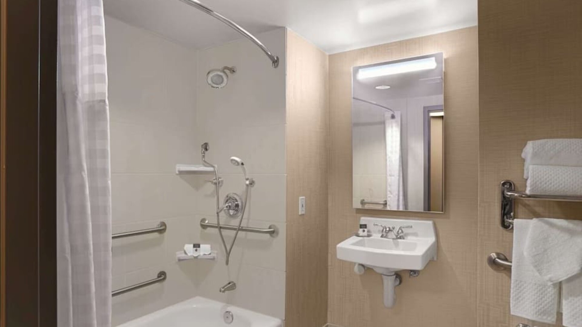 Private guest bathroom with combined shower and tub at DoubleTree By Hilton San Francisco Airport North Bayfront.
