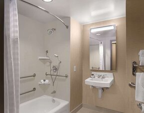 Private guest bathroom with combined shower and tub at DoubleTree By Hilton San Francisco Airport North Bayfront.