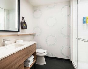 Private guest bathroom at Tru By Hilton Denver Downtown Convention Center.