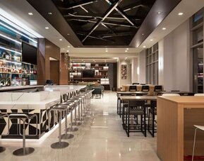 Hotel bar with lounge area perfect for coworking at Tru By Hilton Denver Downtown Convention Center.