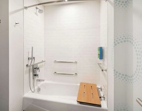 Private guest bathroom with combined shower and tub at Tru By Hilton Denver Downtown Convention Center.