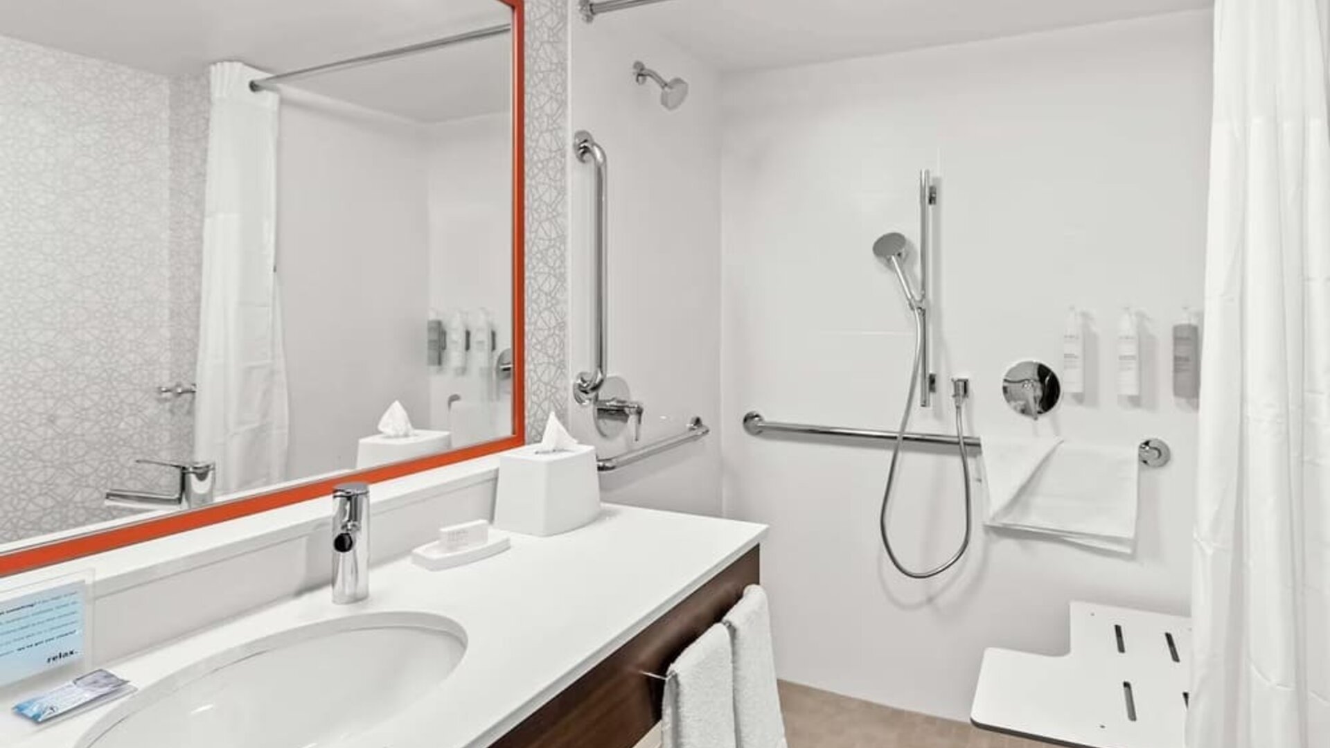 Private guest bathroom with shower and free toiletries at Hampton Inn Chicago/Naperville.