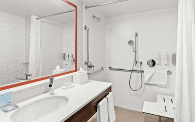 Private guest bathroom with shower and free toiletries at Hampton Inn Chicago/Naperville.