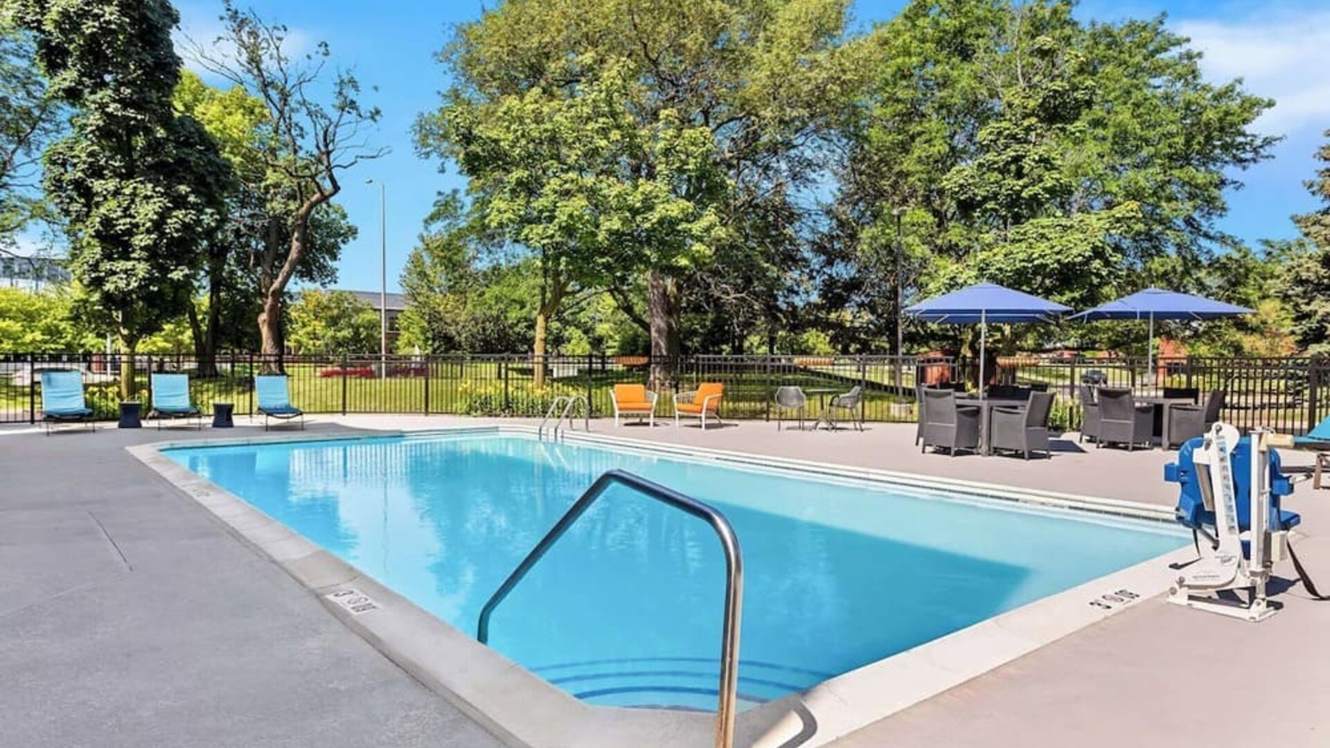 Outdoor pool with lounge chairs at Hampton Inn Chicago/Naperville.