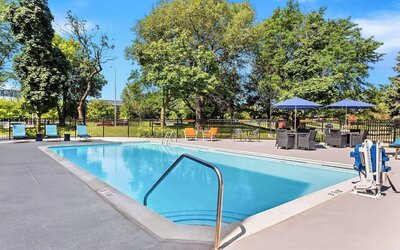 Outdoor pool with lounge chairs at Hampton Inn Chicago/Naperville.