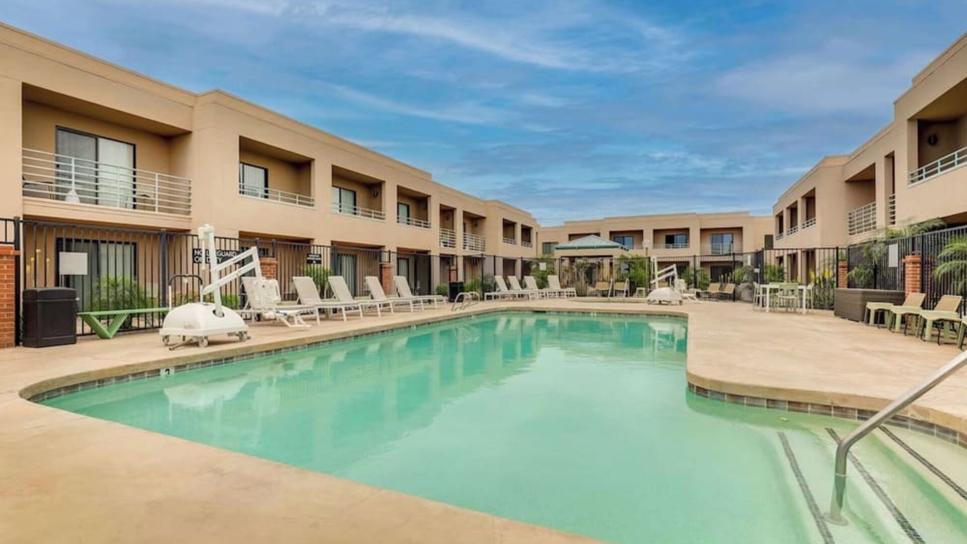 Outdoor pool with lounge chairs at Sonesta Select Scottsdale At Mayo Clinic Campus.