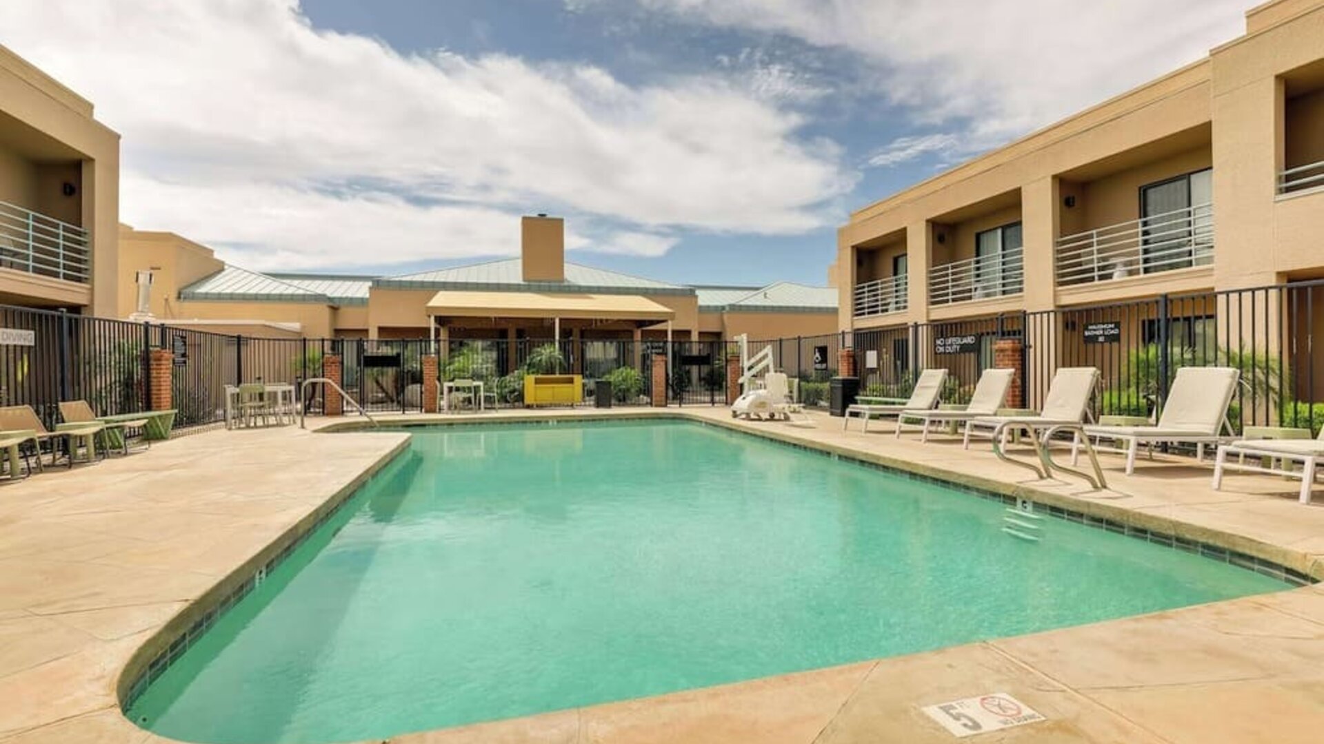 Relaxing outdoor pool with lounge chairs at Sonesta Select Scottsdale At Mayo Clinic Campus.