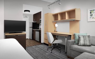 Day room amenities include TV, work desk, sofa, and in-room kitchen at TownePlace Suites Franklin Cool Springs.