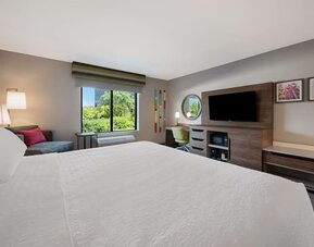 Day use room with work desk and sofa at Hampton Inn Detroit Southfield.
