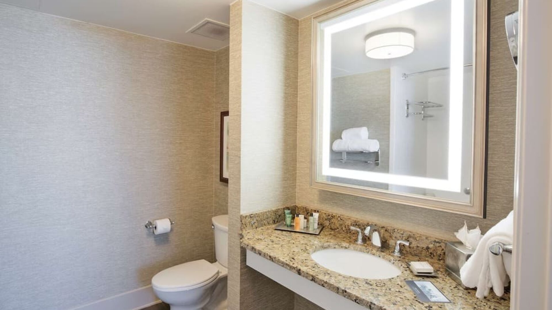 Private guest bathroom with shower and free toiletries at Hilton Baton Rouge Capitol Center.