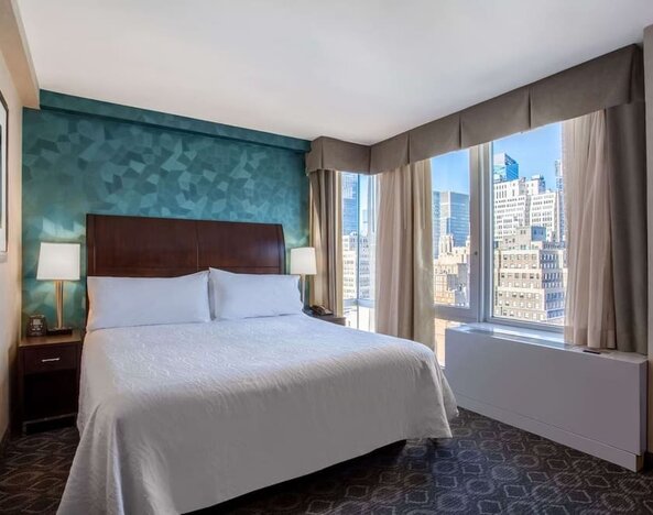 King bedroom with city views at Hilton Garden Inn New York/West 35th Street.
