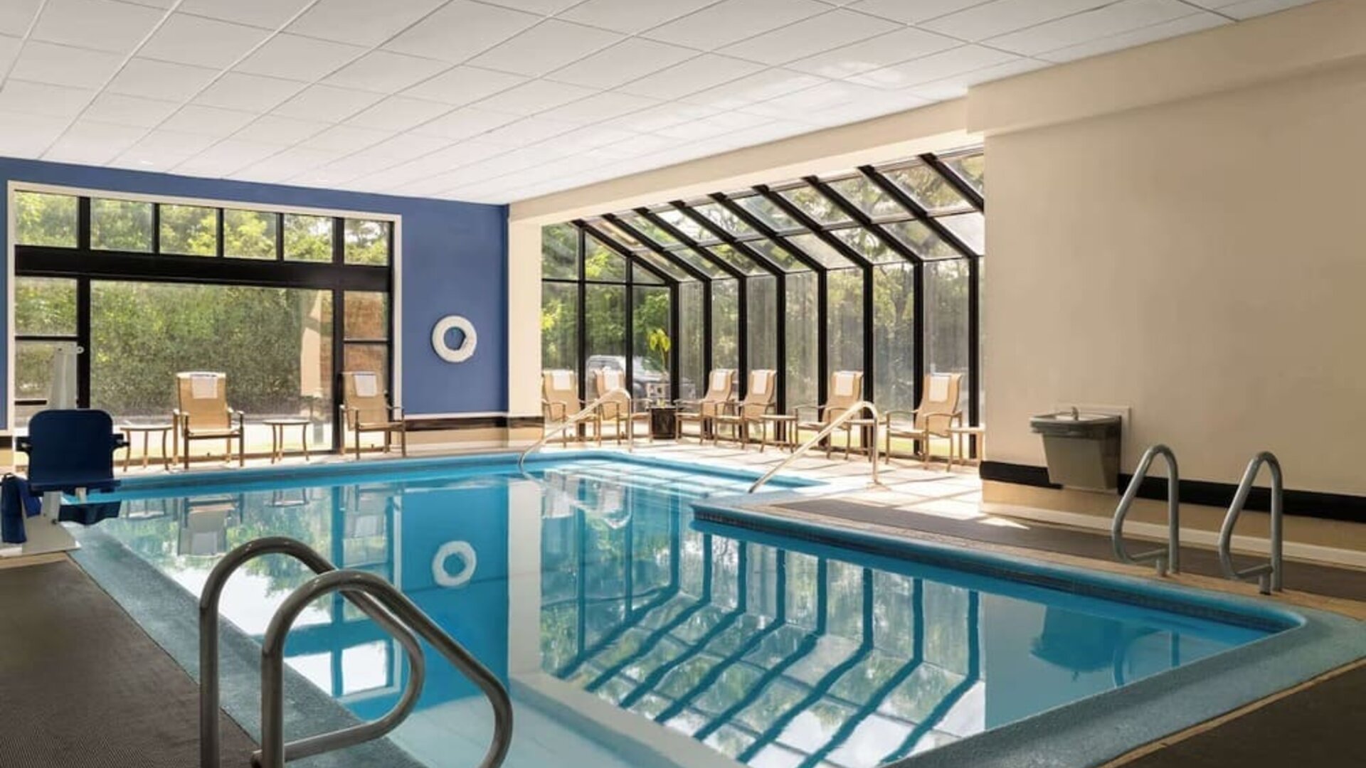Indoor heated pool with lounge chairs at DoubleTree By Hilton Hartford - Bradley Airport.
