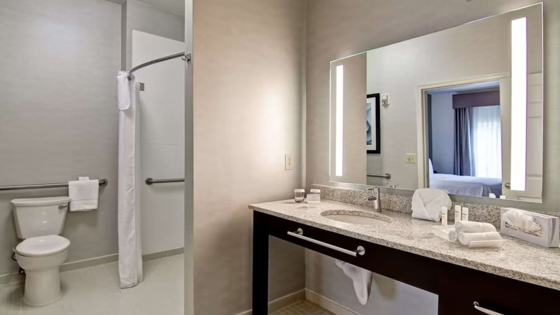 Private guest bathroom with shower and free toiletries at Homewood Suites By Hilton Newark-Cranford.