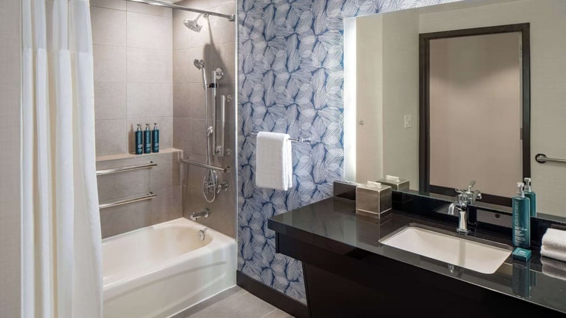 Guest bathroom with shower and tub at Hilton San Antonio Hill Country.