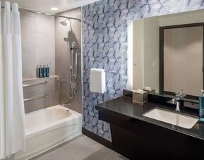 Guest bathroom with shower and tub at Hilton San Antonio Hill Country.