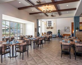 Dining area with natural light perfect for coworking at Hilton San Antonio Hill Country.
