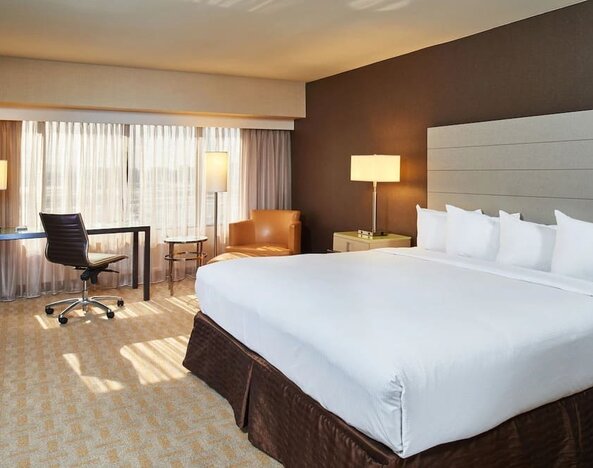 Spacious day use room with work desk and natural light at Hilton Los Angeles Airport.