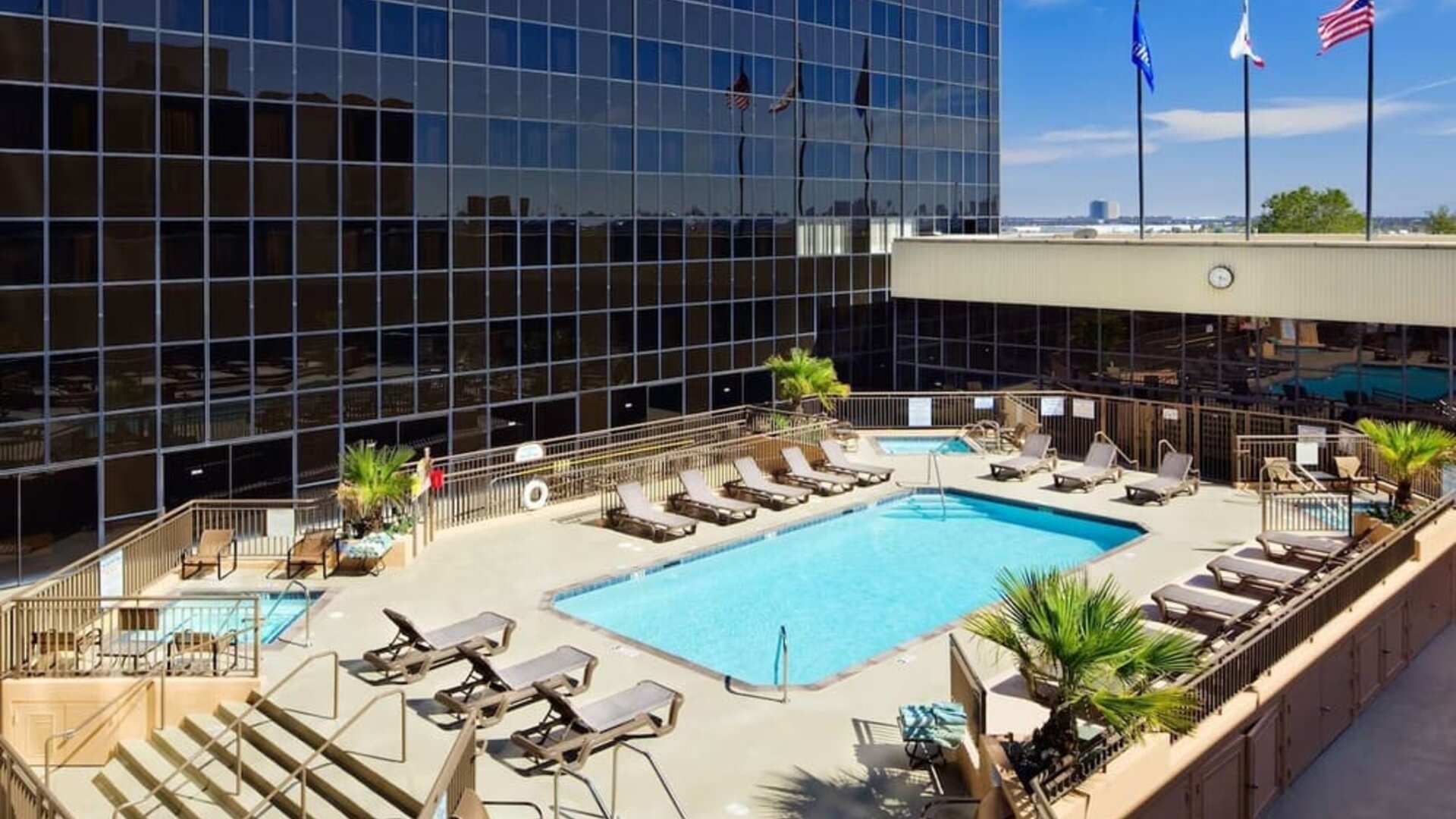 Stunning outdoor pool surrounded by loungers at Hilton Los Angeles Airport.