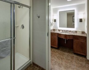 Private guest bathroom with shower and free toiletries at Homewood Suites By Hilton Denton.