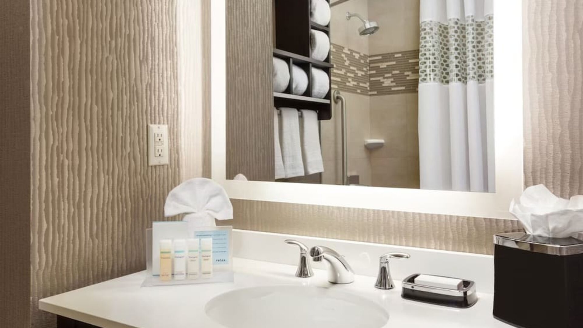 Private guest bathroom with shower and free toiletries at Hampton Inn Manhattan/Times Square Central.