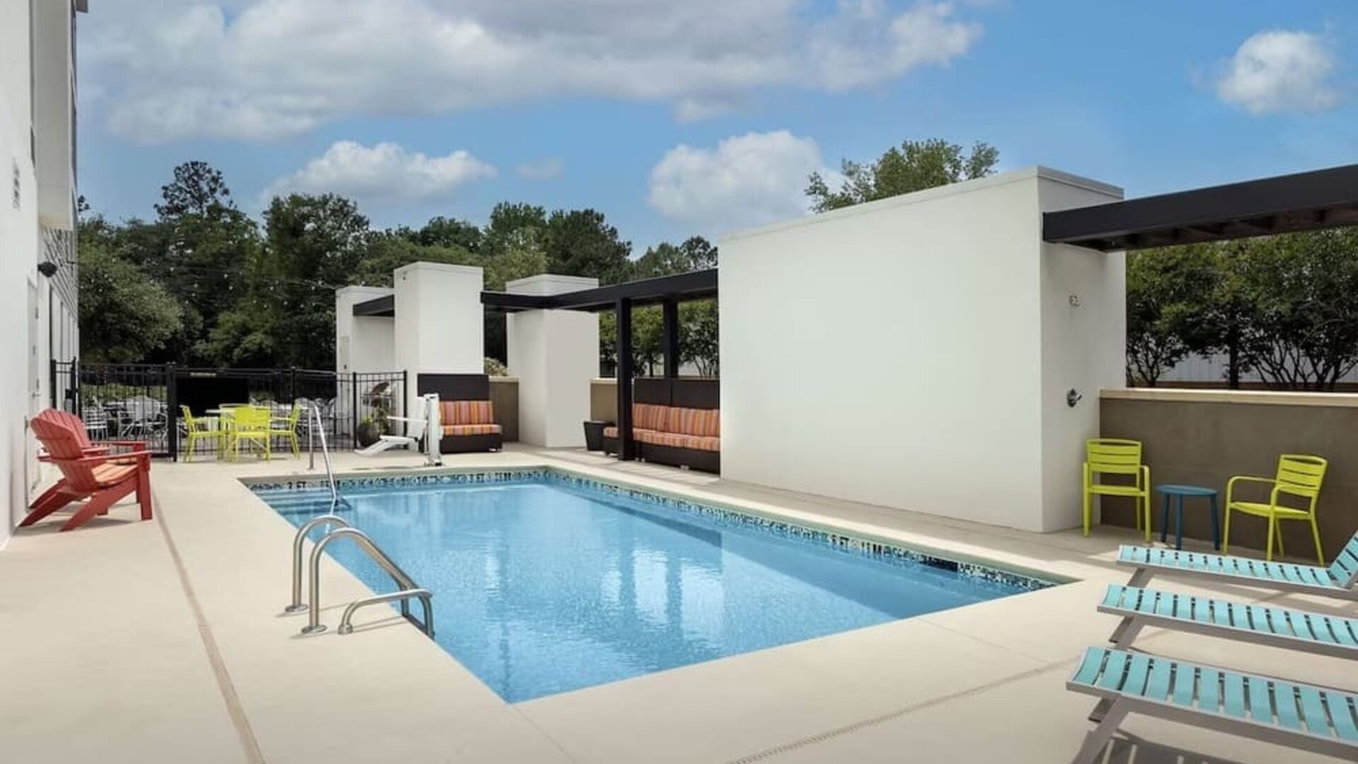 Stunning outdoor pool with seating area at Home2 Suites By Hilton Charleston Airport/Convention Center.