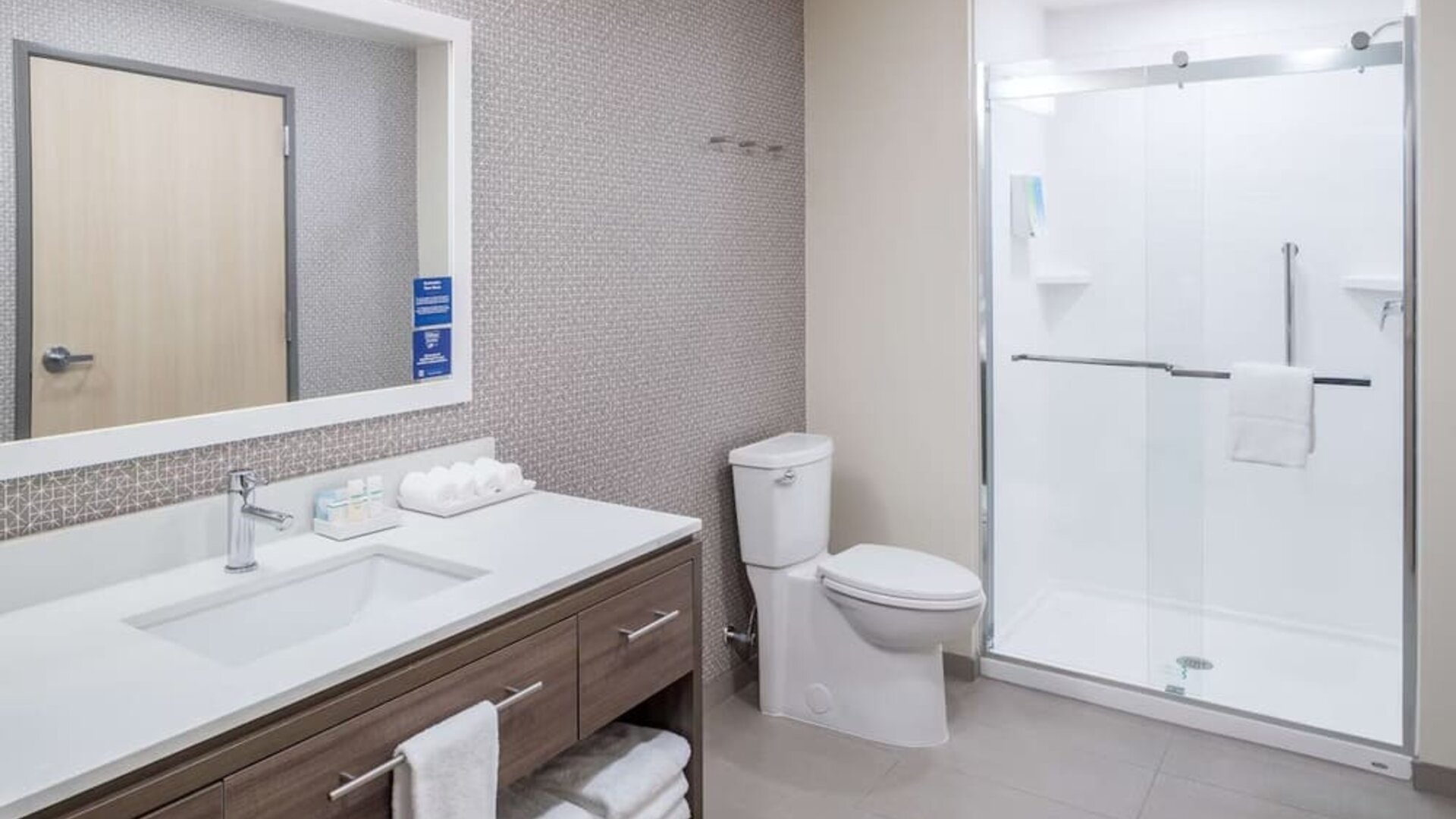 Private guest bathroom with shower and free toiletries at Home2 Suites By Hilton Cape Canaveral Cruise Port.