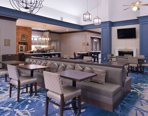 Dining area with comfortable seating, perfect for coworking at Homewood Suites By Hilton Dallas-Lewisville.