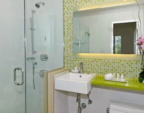 Private guest bathroom with shower and free toiletries at Circa 39 Hotel.