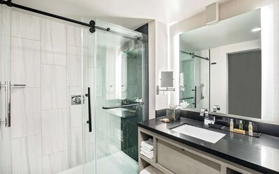 Private guest bathroom with shower and free toiletries at DoubleTree By Hilton Washington DC North/Gaithersburg.