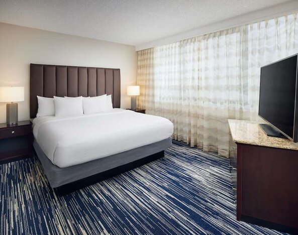 King bed at Embassy Suites By Hilton West Palm Beach Central.