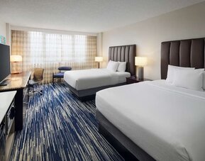 Bright and spacious day use twin room with work desk at Embassy Suites By Hilton West Palm Beach Central.