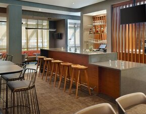 On-site bar with lounge seating and workspace, perfect for coworking at 	SpringHill Suites Atlanta Northwest.